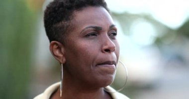 Pensive African woman thinking. Contemplative black lady in deep think outside