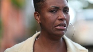 Black woman with a disgust face portrait, african lady with aversion emotion nausea