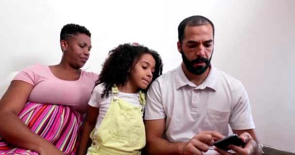 Multiracial Parents Child Looking Cellphone — Stock Video