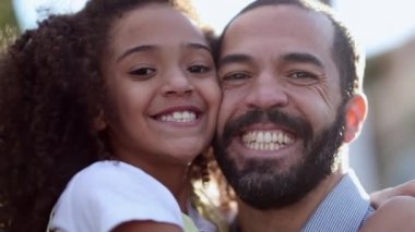 Father and child daughter smiling together at camera, mix race parent and kid portraits