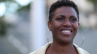 Happy African woman smiling outside portrait face close-up