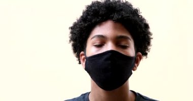 Boy removing covid-19 face mask feeling relief