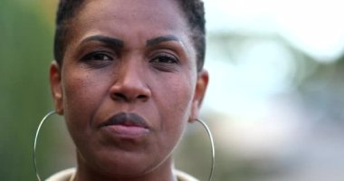 Confident black African woman smiling. Proud mixed race individual portrait face close-up