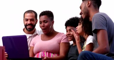 African family talking with relatives on webcam laptop at home couch