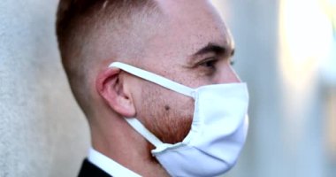 Man wearing pandemic face mask outside