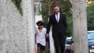 Father and child son relationship together, mixed race kid with redhair dad walking together, real life and authentic