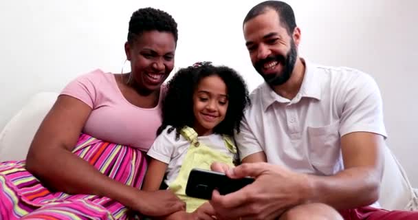 Interracial Parents Mixed Race Child Daughter Looking Cellphone Laughing Smiling — Αρχείο Βίντεο