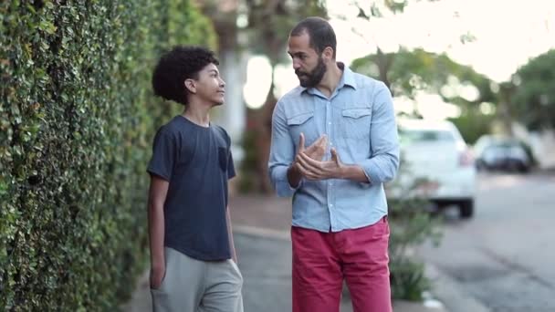 Father Mentoring Son Dad Young Boy Walking Together Sidewalk Talking — Vídeo de Stock