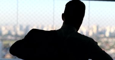 Silhouette of business man putting on suit in the morning, office executive preparing routine