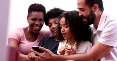 Happy family looking smartphone device