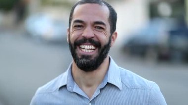 Casual man smiling and laughing outside