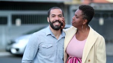 Mixed race couple relationship outside, black wife caring for husband