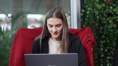 Happy woman using laptop computer liking positive message. Excited person using modern technology smiling