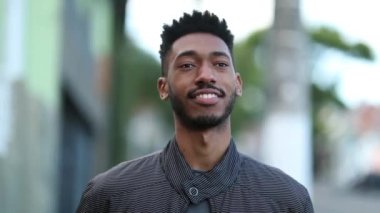 Portrait black African young man standing outside