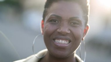 Portrait black mix race woman smiling at camera outside