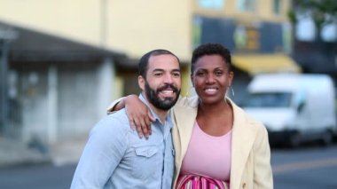 Interracial mix race couple smiling at camera, ethnically diverse married couple