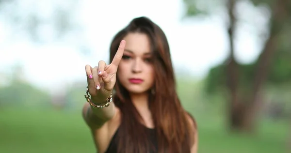 Annoyed attracrtive woman rejecting with hand and finger telling viewer NO, defending stand