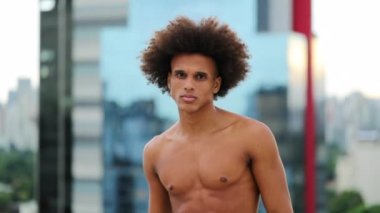 Young shirtless black man in urban city