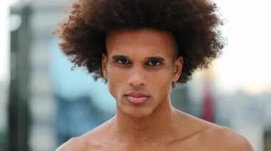 Shirtless lean young black african man staring camera