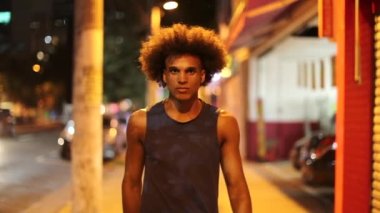 Young african black man walking in the city at night