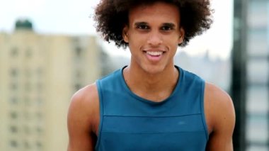 Happy confident young black man smiling with afro