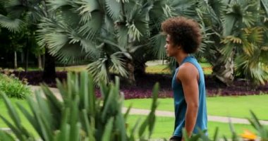 African american young man walking at park leisure walk
