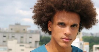 African young man looking to camera with serious expression