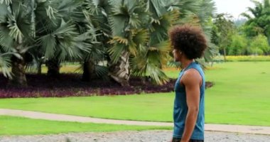 African black man walking at park in nature, leisure walking