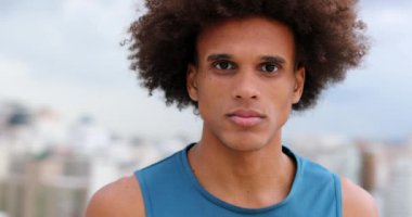 Portrait of mixed race young man smiling and feeling happy. African descent person looking to camera with smile