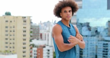 Sportive Portrait of young handsome mixed race american man looking to camera with arms crossed