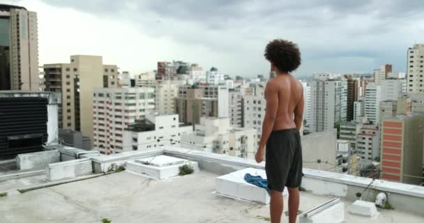 Young Mixed Race Man Standing Shirtless Top Rooftop Looking City — Video Stock