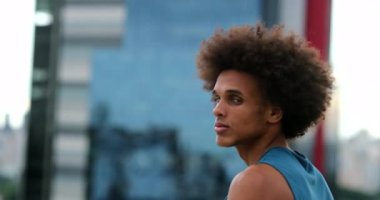 Portrait of handsome young african mixed race man smiling to camera feeling joy. Confident black man turning head towards camera