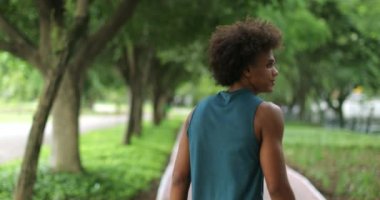 Young handsome black african man turning around and smiling to camera