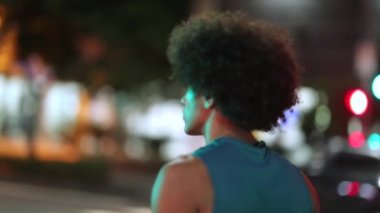 African black man walking in the city at night