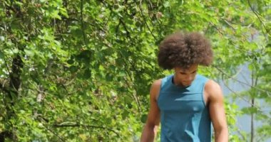 African man walking at park in nature