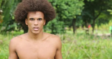 Portrait of young handsome african black shirtless man looking to camera