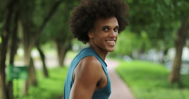 Happy Smiling Young African Man Walking Park Backwards Looking Camera — 图库视频影像