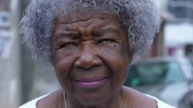 An older woman looking up at the sky person eyes looks up