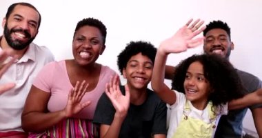 Black African family waving hello to camera, parent and kids talking to camera POV