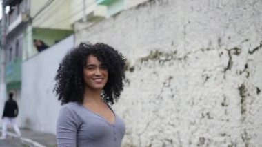 A happy diverse young black woman turning to camera smiling