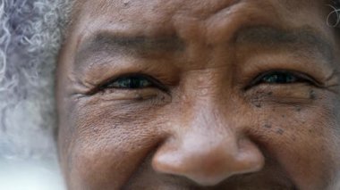 A happy senior woman macro eyes closeup smiling at camera