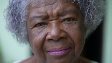 Portrait of a serious senior African woman face looking at camera