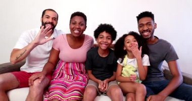 Casual family talking to camera in video conference POV