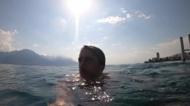 Man swimming at lake suring summer
