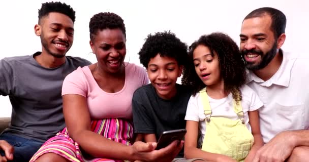 Счастливая Смешанная Раса Семьи Глядя Телефон Устройство Смеясь Улыбаясь — стоковое видео