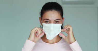 Woman using face mask prevention for Corona virus outbreak. Girl covering face with surgical mask