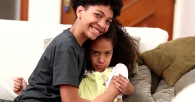 Brother trying to console upset little sister. mixed race black ethnicity