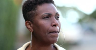 Pensive African woman thinking. Contemplative black lady in deep think outside