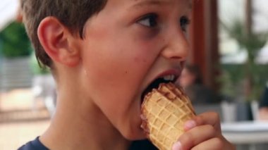 Child eating ice-cream. Young boy eats dessert chocolate ice cream