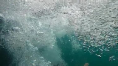 Bubbles in super slow-motion water liquid in 240fps rising to surface